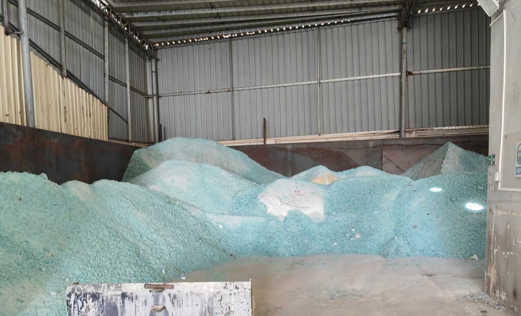 Sodium silicate production raw materials including quartz sand and soda ash piled at factory raw material yard with conveyor system