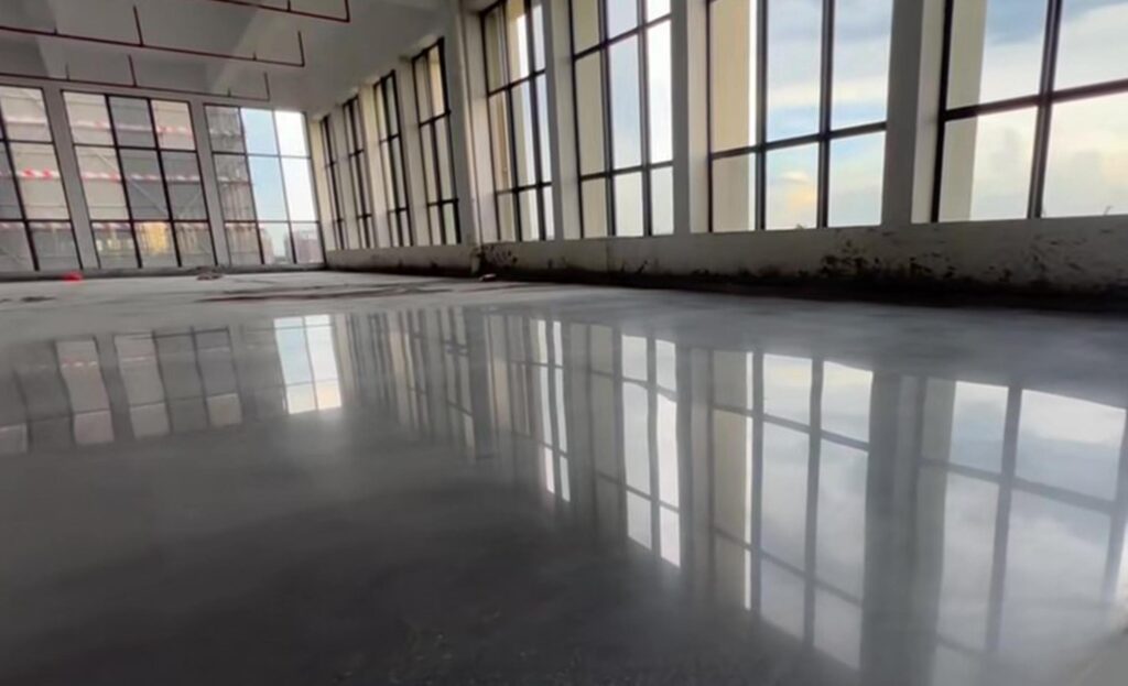 Concrete sealing and curing agent floor coating application showing densified polished surface water beading and enhanced hardness