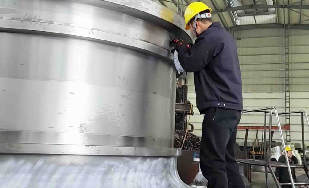 Large castings industrial components including heavy machinery frame valve body and propeller in foundry workshop