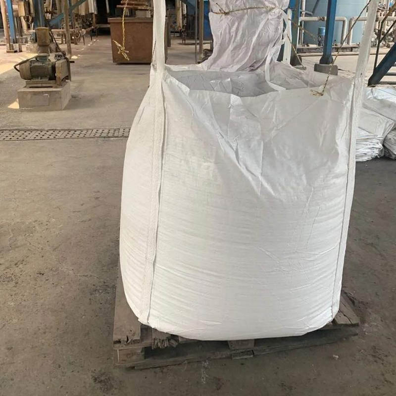Ton-bag packaged solid water glass with FIBC jumbo bags containing blue-green sodium silicate cullet ready for shipment in warehouse