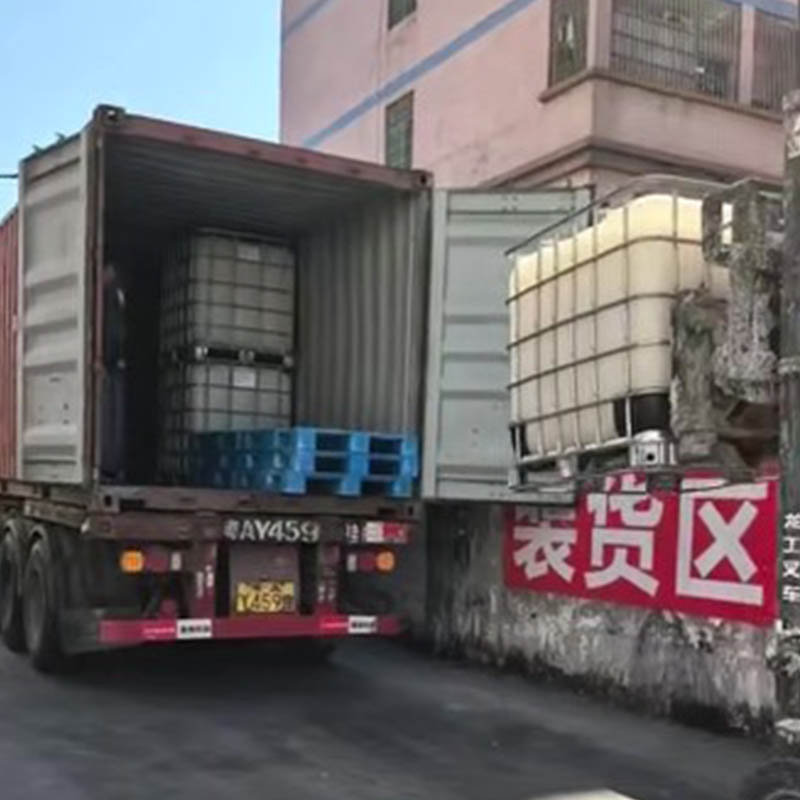 Loading container of liquid sodium silicate with forklift placing IBC totes into 20ft shipping container for export shipment