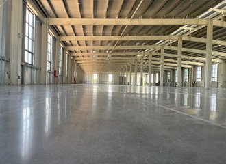 Densified concrete warehouse floor treated with lithium silicate sealer showing polished dust-free surface with forklift traffic