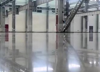 Densified concrete factory floor treated with silicate hardener showing wear resistant dust free surface with heavy machinery