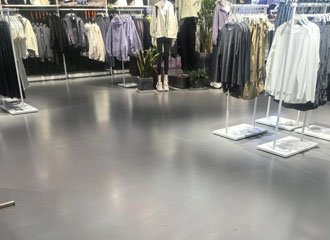 Silicate densified commercial building concrete floor showing high gloss polished finish in retail lobby with light reflection