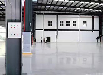 Densified industrial concrete floor in manufacturing plant treated with lithium silicate hardener showing wear resistant surface