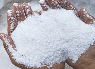 Spray-drying tower for powder detergent manufacturing with sodium silicate builder incorporated for improved flow properties