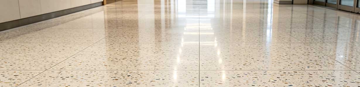 Lithium silicate densifier being sprayed on concrete floor with low-pressure sprayer showing deep penetration and densification process