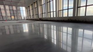 Concrete sealing and curing agent floor coating application showing densified polished surface water beading and enhanced hardness