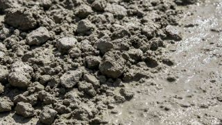 Sodium silicate concrete application showing hardened densified surface with water beading and dust-free finish